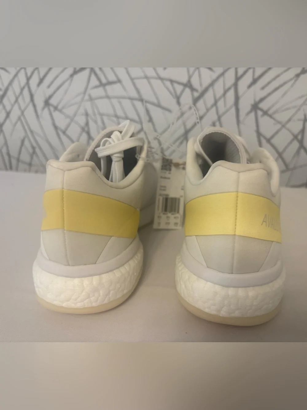 adidas Avaluxe tennis shoes in white with subtle pastel yellow accents. JQ7080